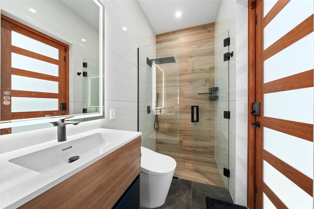 2631 Northeast 48th Court Lighthouse Point, FL 33064 - Photo 46 of 74 a bathroom with a sink a toilet and shower