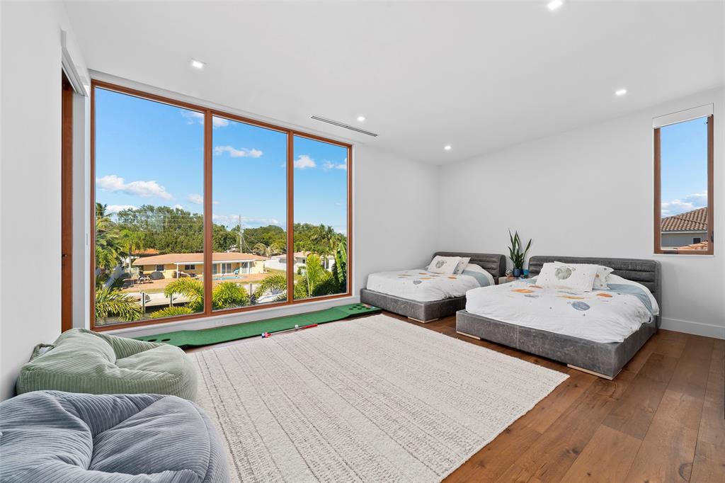 2631 Northeast 48th Court Lighthouse Point, FL 33064 - Photo 47 of 74 a bedroom with two large bed and a large window