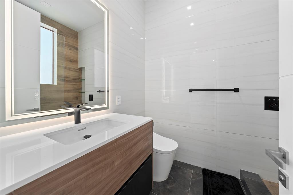 2631 Northeast 48th Court Lighthouse Point, FL 33064 - Photo 48 of 74 a bathroom with a sink and a mirror