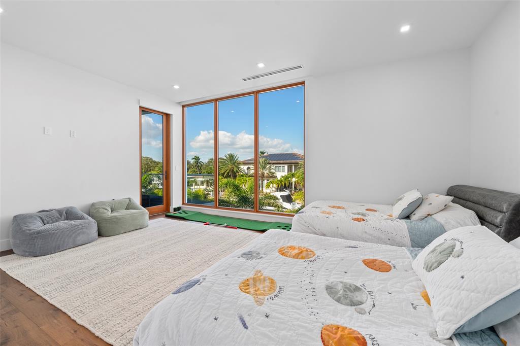 2631 Northeast 48th Court Lighthouse Point, FL 33064 - Photo 50 of 74 a bedroom with a bed and a window