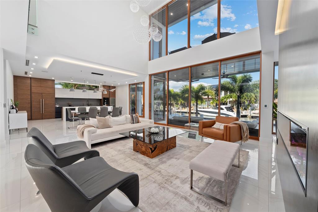 2631 Northeast 48th Court Lighthouse Point, FL 33064 - Photo 5 of 74 a living room with fireplace furniture and a large window