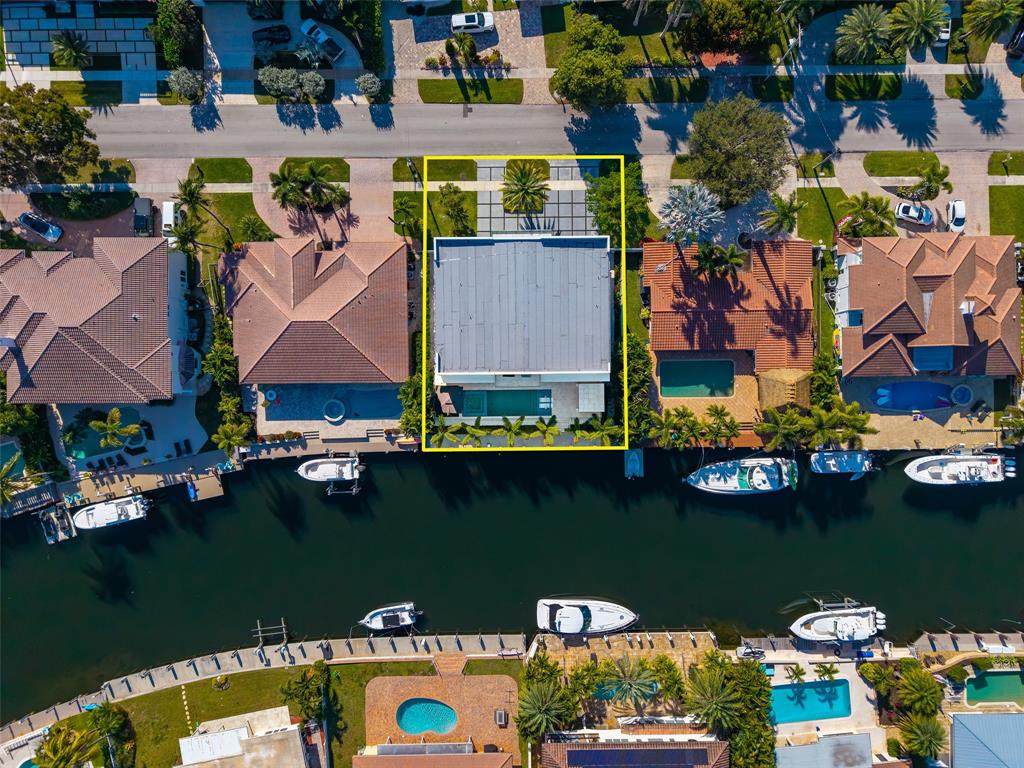 2631 Northeast 48th Court Lighthouse Point, FL 33064 - Photo 68 of 74 an aerial view of a house with outdoor space swimming pool and outdoor seating