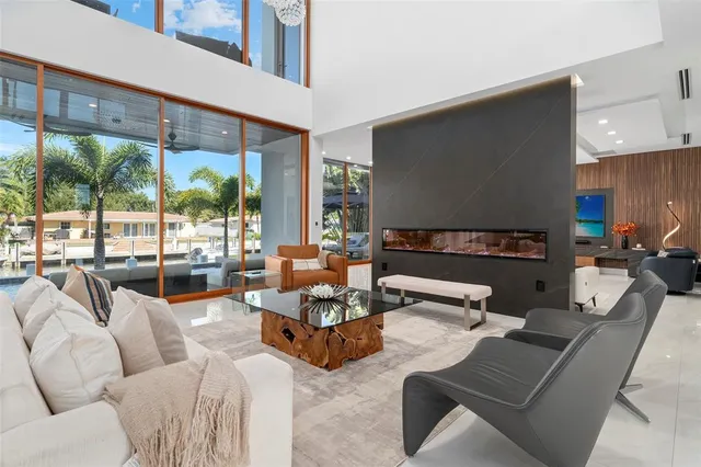 a kitchen with stainless steel appliances kitchen island granite countertop a stove a sink a refrigerator and a wooden cabinets