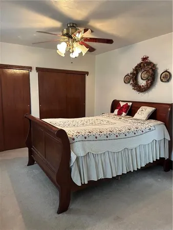a bedroom with a bed and a chandelier