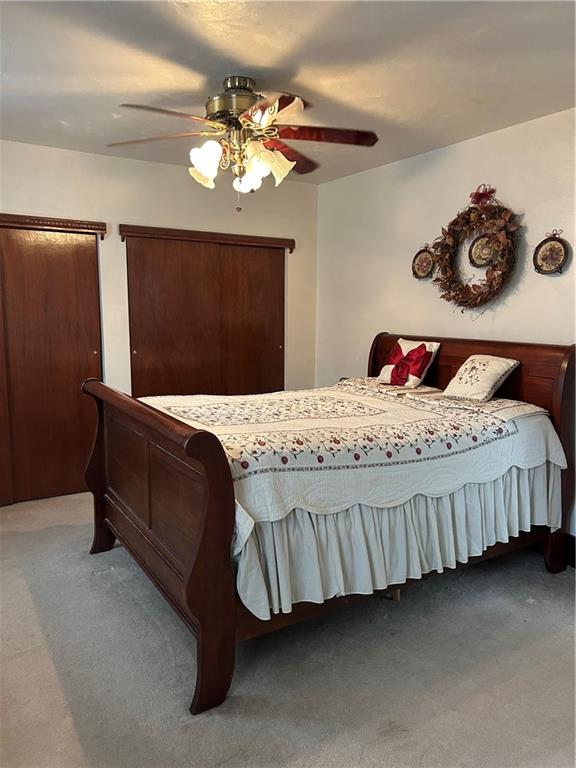 419 Indiana Avenue Monessen, PA 15062 - Photo 12 of 19 a bedroom with a bed and a chandelier