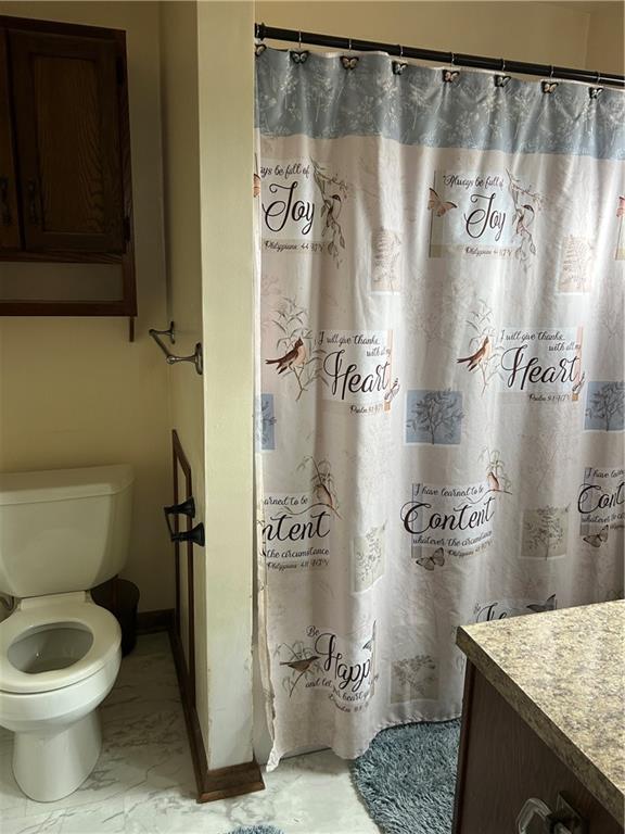 419 Indiana Avenue Monessen, PA 15062 - Photo 15 of 19 a bathroom with a granite countertop sink a toilet and a shower