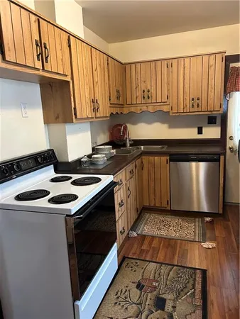 a kitchen with a sink stove and cabinets