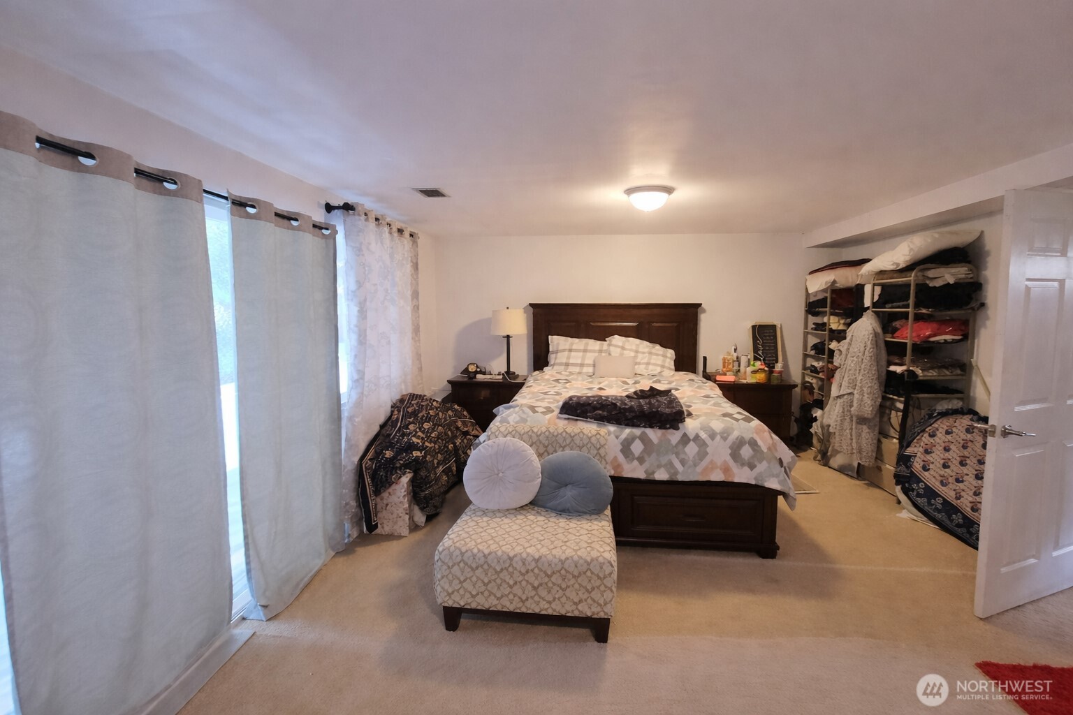 14600 Southeast 181st Street Renton, WA 98058 - Photo 18 of 39 a bedroom with a bed and a walk in closet