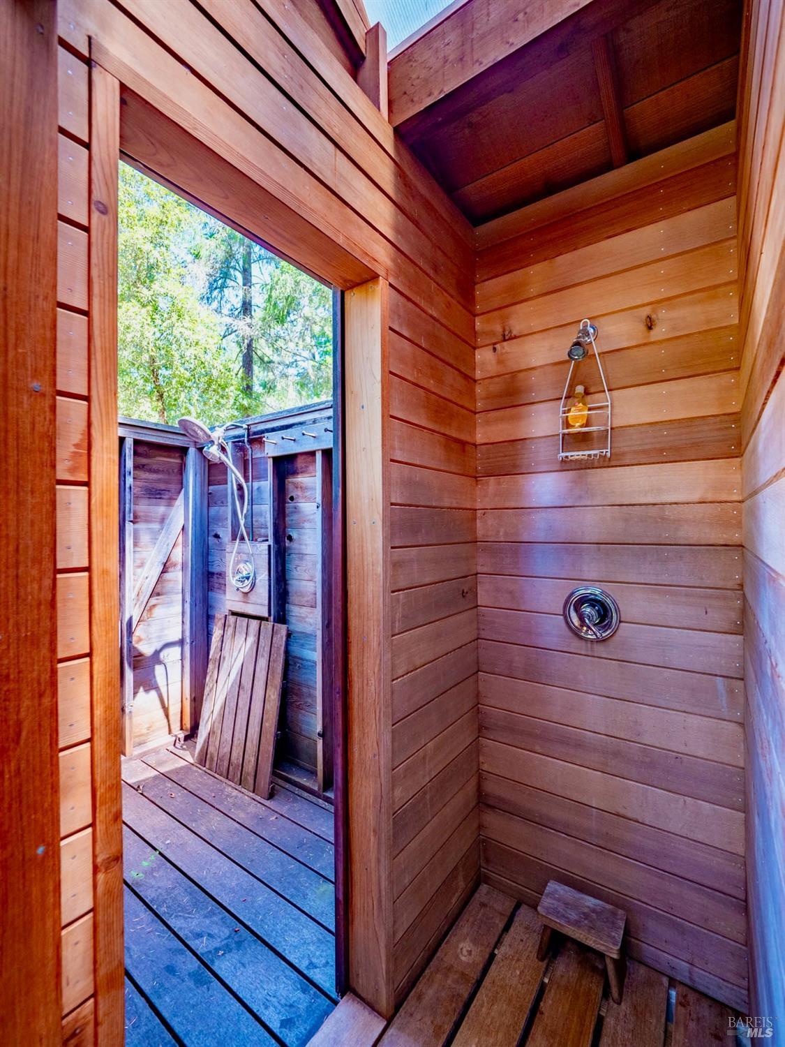 10951 Big Meadow Road Philo, CA 95466 - Photo 40 of 46 A deck offers a peaceful outdoor sitting area and leads to the charming bathhouse with indoor/outdoor showers and a composting toilet.