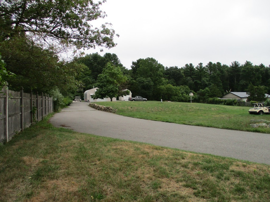 396 Marion Road Middleboro, MA 02346 - Photo 18 of 29 a view of a yard with potted plants and big trees