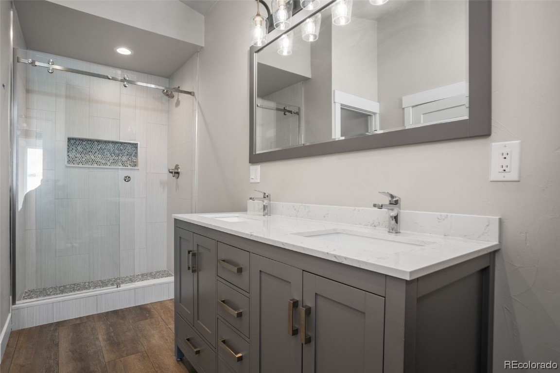 932 Dry Creek Road Hayden, CO 81639 - Photo 20 of 24 a bathroom with a shower sink vanity and mirror