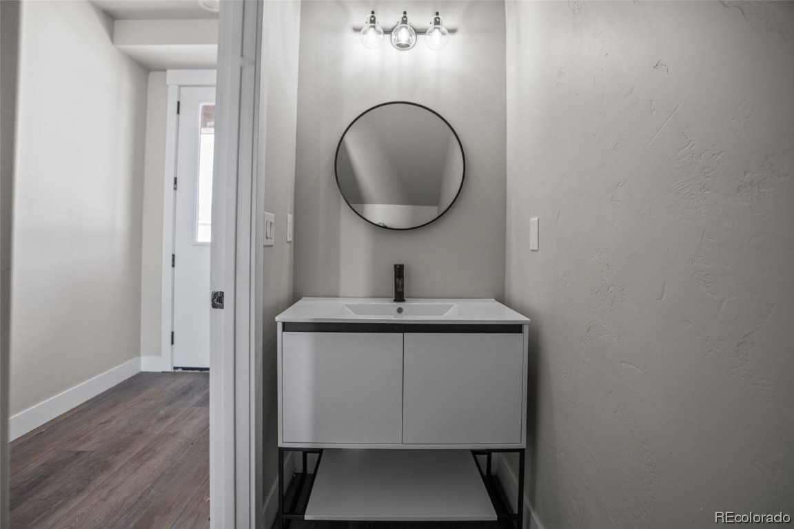 932 Dry Creek Road Hayden, CO 81639 - Photo 21 of 24 a bathroom with a toilet a sink and mirror