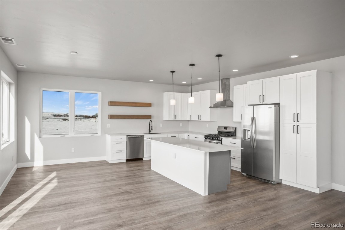 932 Dry Creek Road Hayden, CO 81639 - Photo 3 of 24 a kitchen with a refrigerator and a stove top oven