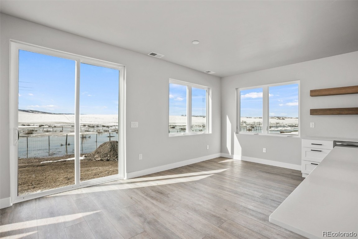 932 Dry Creek Road Hayden, CO 81639 - Photo 6 of 24 a view of a kitchen with wooden floor and electronic appliances