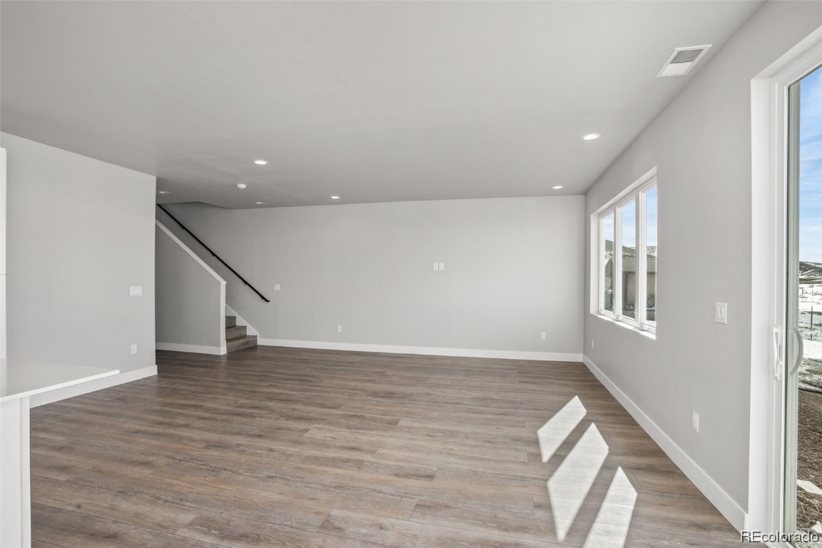 932 Dry Creek Road Hayden, CO 81639 - Photo 7 of 24 a view of an empty room with wooden floor and stairs