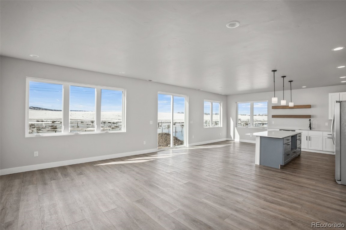 932 Dry Creek Road Hayden, CO 81639 - Photo 8 of 24 a view of an empty room with kitchen and window