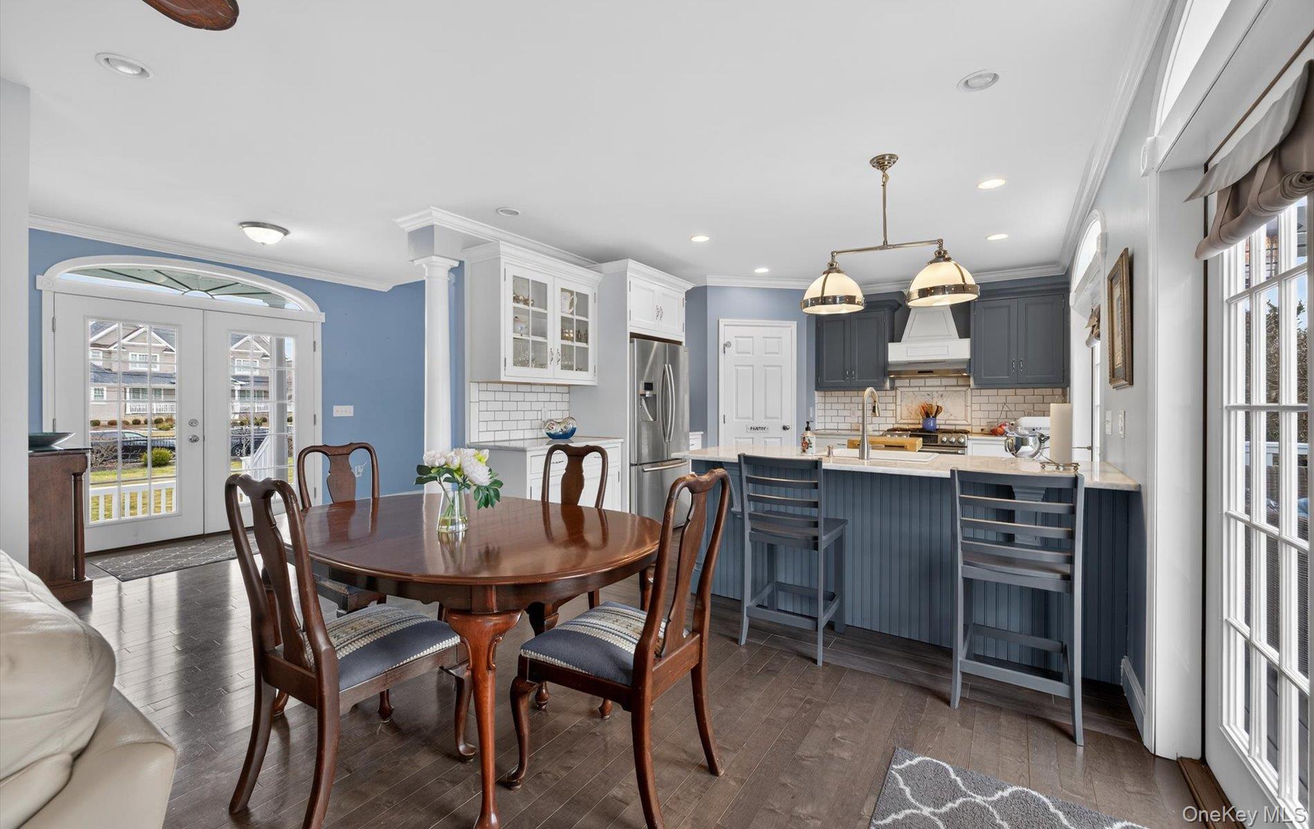 108 Awixa Avenue Bay Shore, NY 11706 - Photo 4 of 47 Dining area featuring french doors, crown molding, dark wood-style floors, and recessed lighting
