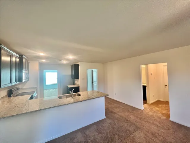 a large bathroom with a large tub and sink