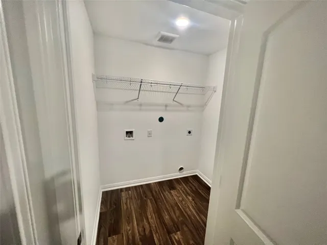 a view of walk in closet with wooden floor