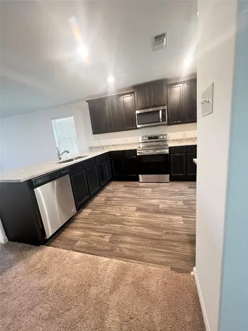 a kitchen with a stove and a refrigerator