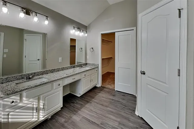 a bathroom with a double vanity sink and a mirror