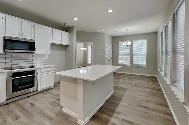 a large kitchen with a stove and a sink