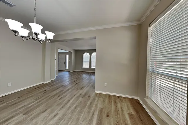 a view of a room with wooden floor