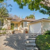 a front view of a house with a garden