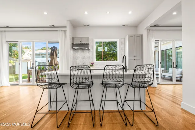 a view of a dining room with furniture wooden floor and a potted plant