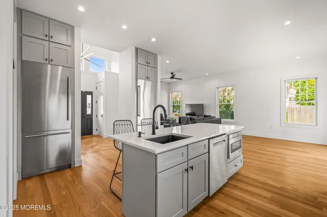 a kitchen with a sink stainless steel appliances and cabinets