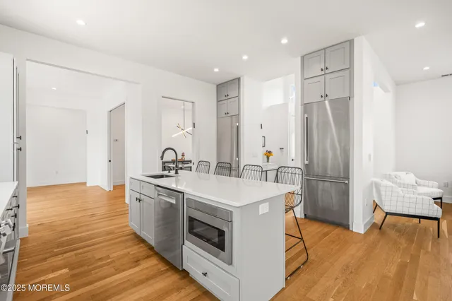 a kitchen with a sink stainless steel appliances and cabinets