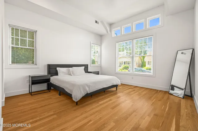 a spacious bedroom with a bed and a window