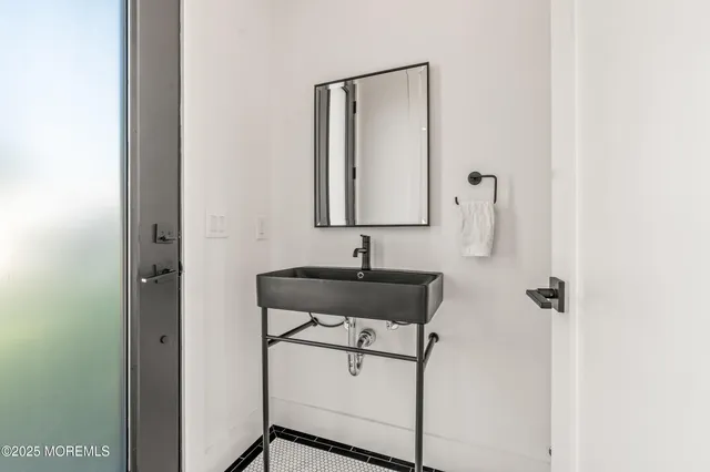a bathroom with a sink a toilet and mirror