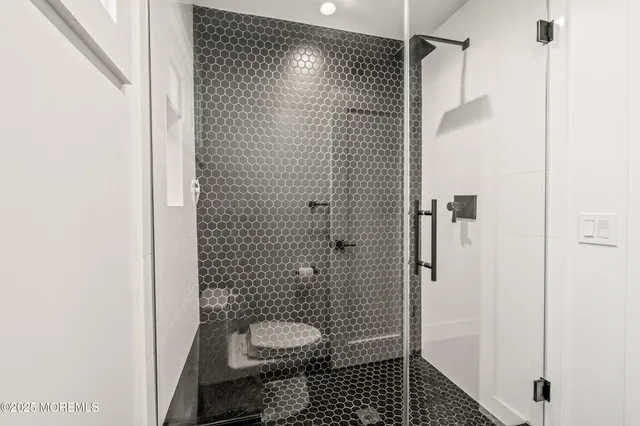 a bathroom with a shower and a toilet