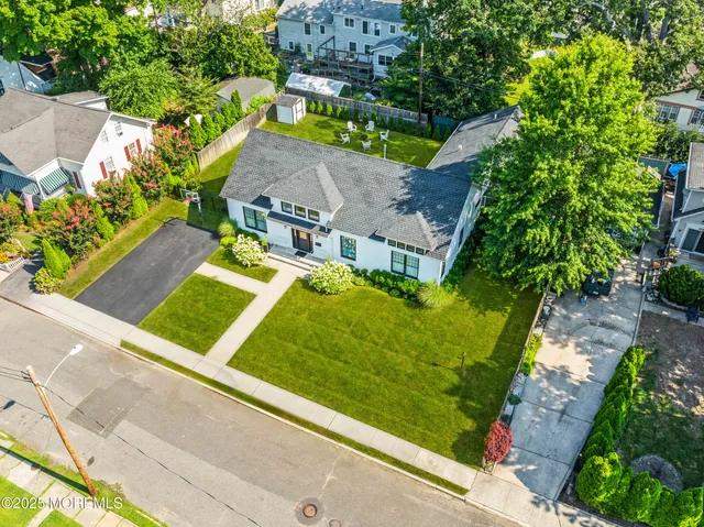 an aerial view of a house with a garden and trees