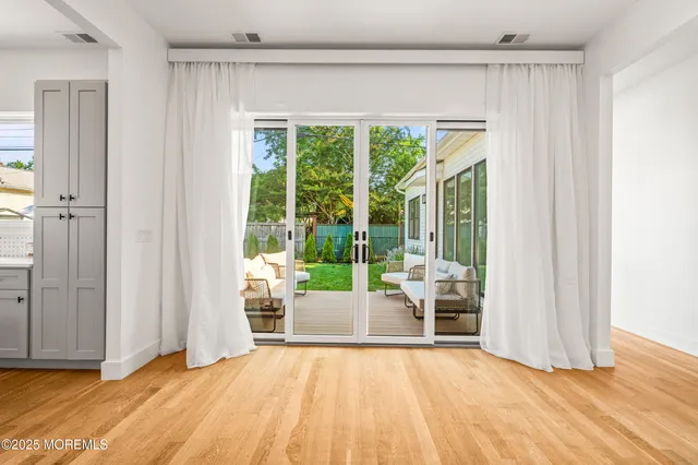a view of a room with wooden floor and furniture