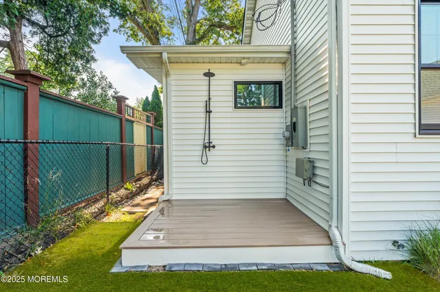 a view of a house with backyard porch and sitting area