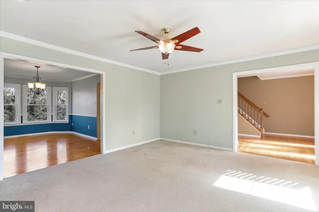 a view of a livingroom with a ceiling fan and window