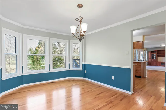 a view of a livingroom with a window and wooden floor
