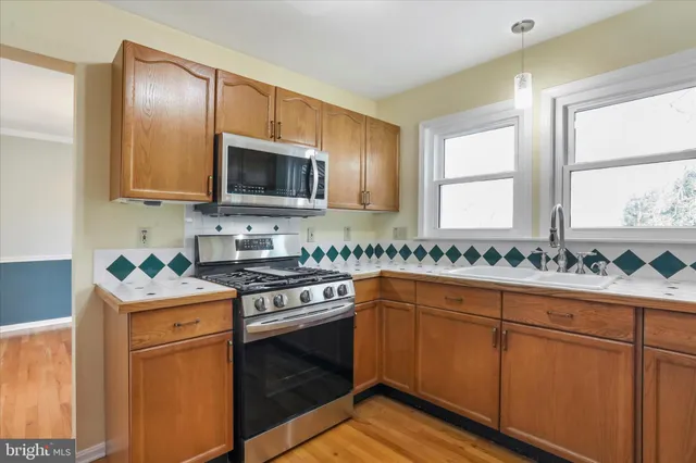 a kitchen with granite countertop cabinets stainless steel appliances and a sink