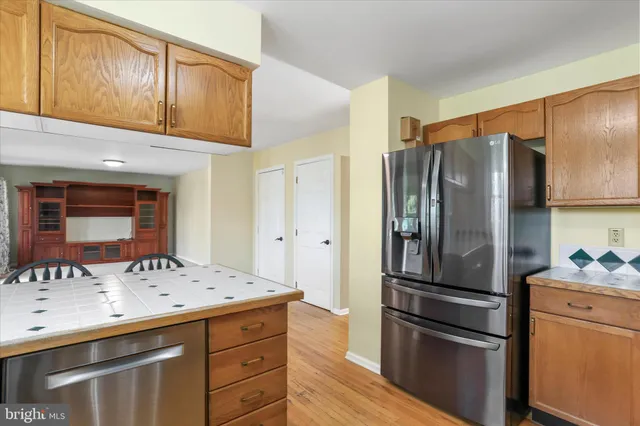 a kitchen with a refrigerator and a sink