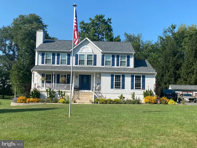 a front view of a house with a yard table and chairs