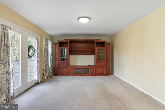 an empty room with furniture and a window