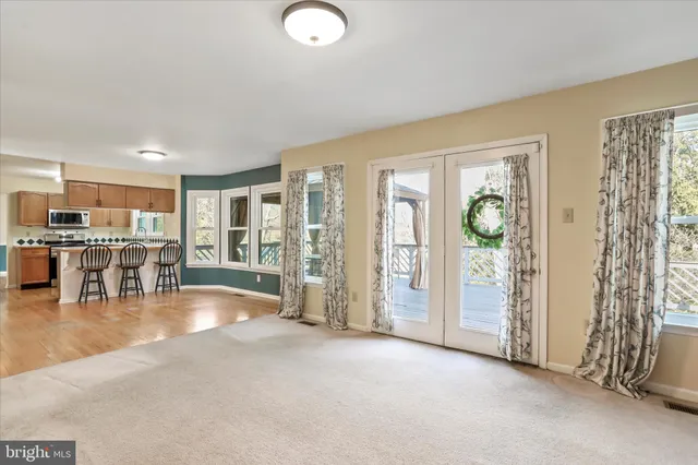 a view of a livingroom with furniture water view and large windows