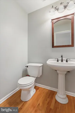 a bathroom with a sink toilet and mirror