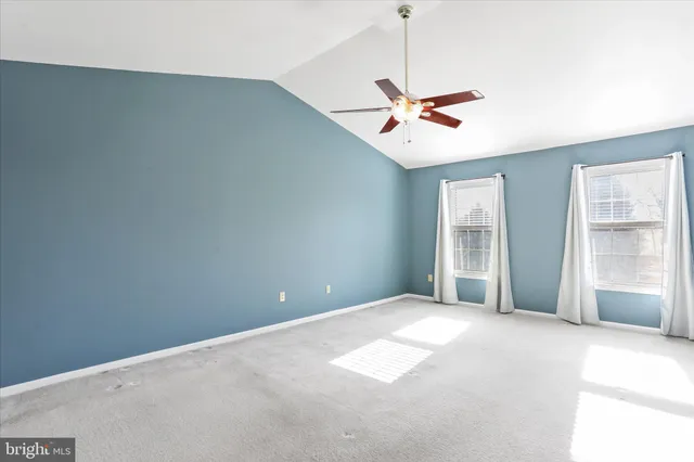 a view of a livingroom with a ceiling fan and window