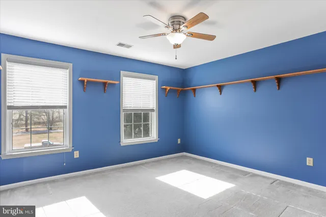 a view of a livingroom with a ceiling fan and a fan