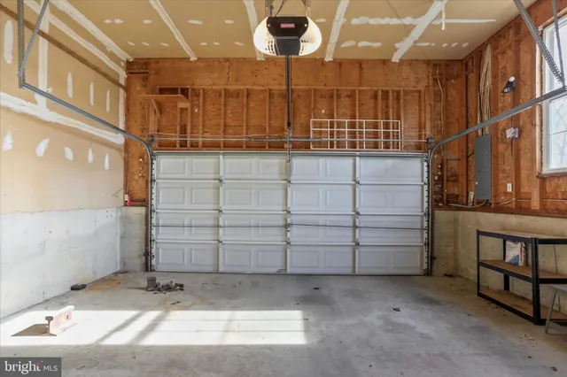 a view of a small house with a garage