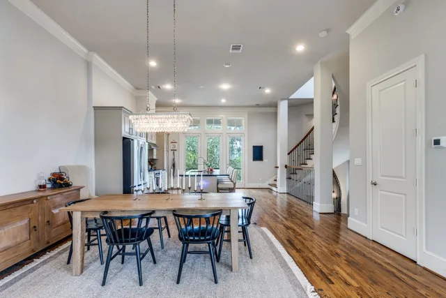 a dining room with furniture entryway and wooden floor