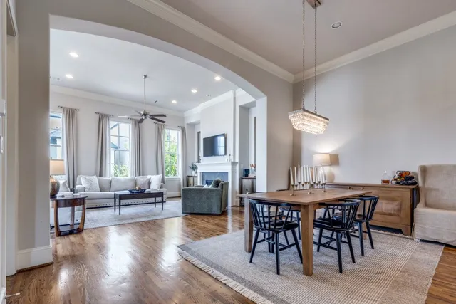 a view of a a dining room with furniture window and wooden floor
